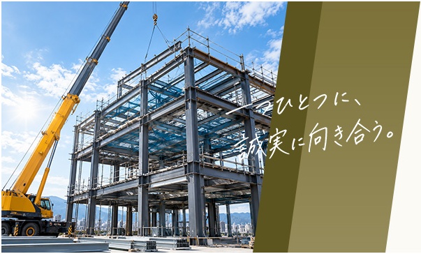 クレーンで鉄骨を組み上げる建設現場